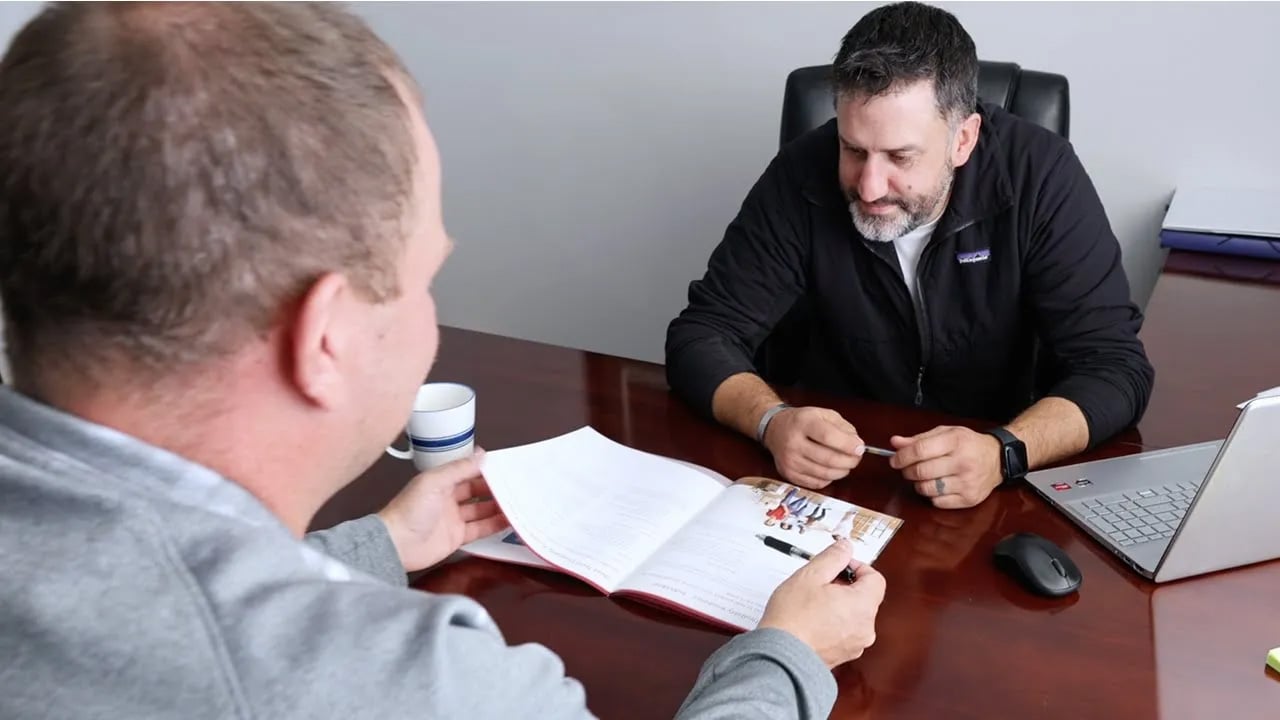 Agent Tony Roach talking with his client about insurance