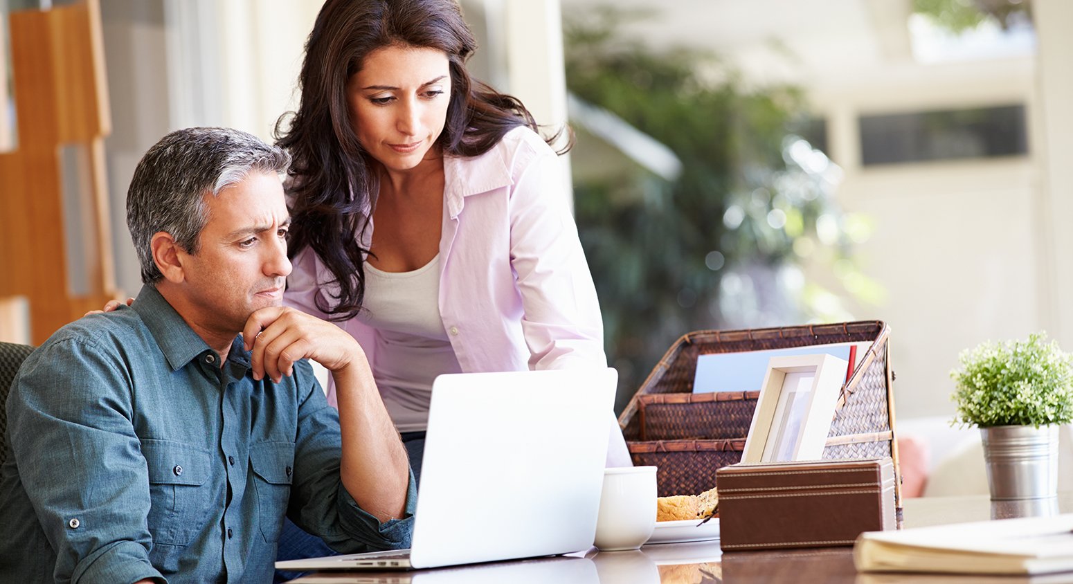 husband and wife looking at laptop together