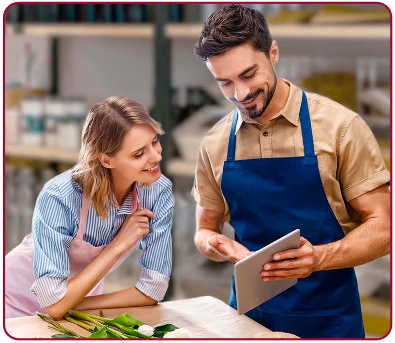 Young small business owners looking at notes