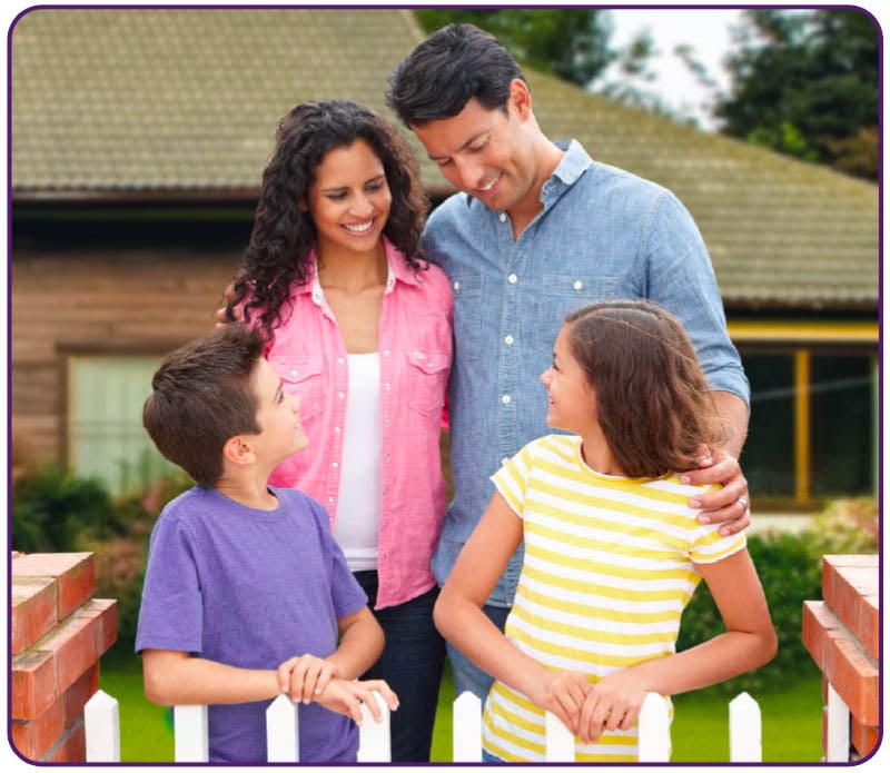 young family outside of their home