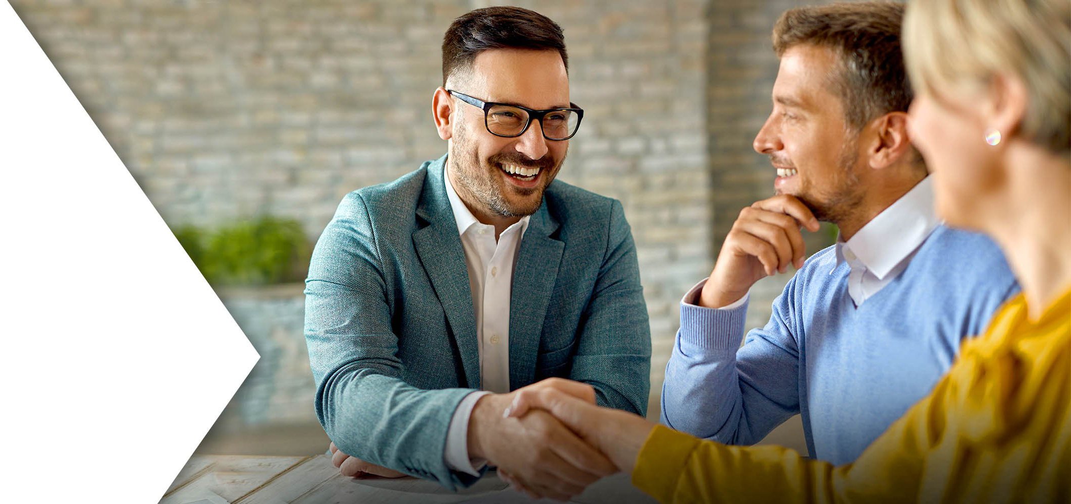 insurance agent shaking hands with clients