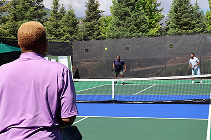 3 agent event attendees in the middle of a pickleball game  thumbnail