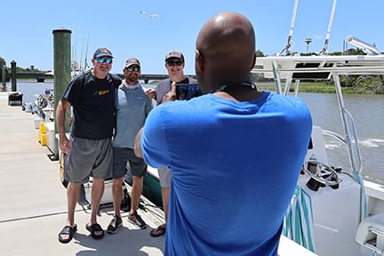 group of fishermen getting their photo taken