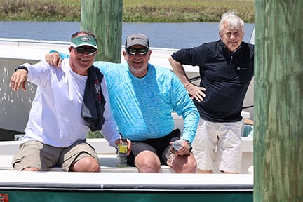 fishermen posing on the boat for a photo
