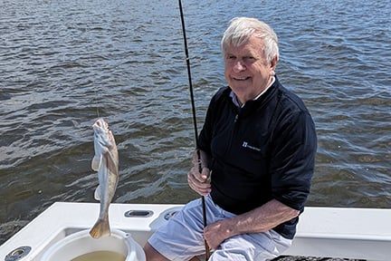 man with a fish that he caught