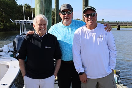 fishermen posing on the dock for a photo