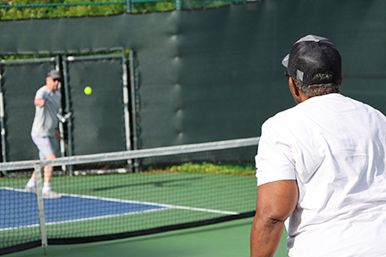 2 pickleball players in the middle of a match