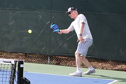 pickleball player returning the ball