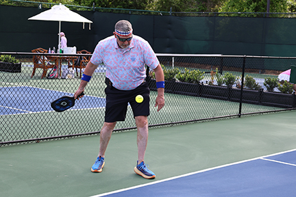 pickleball player serving the ball to the other team