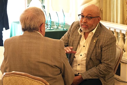 two agents talking at the awards dinner