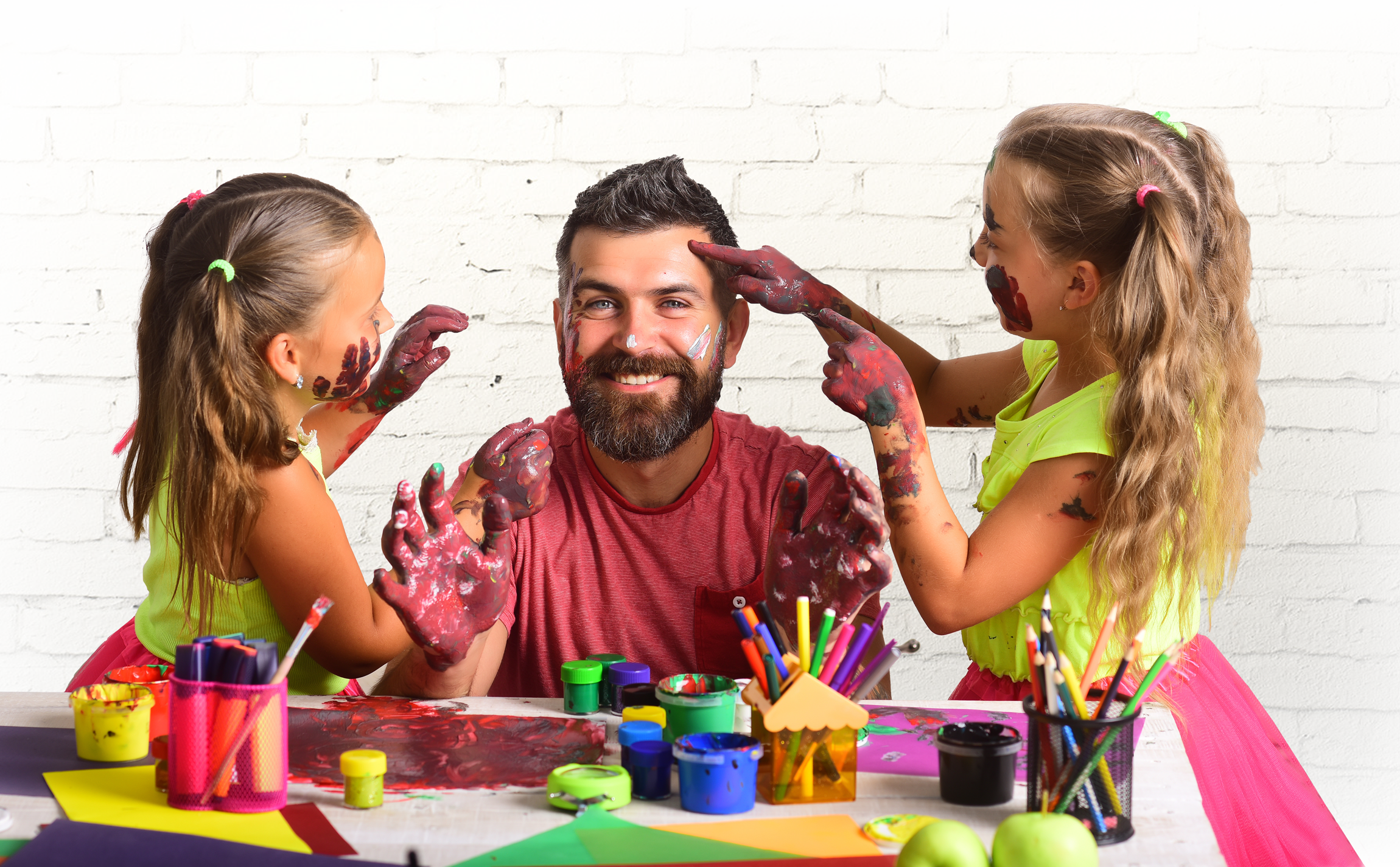 image of a father and his daughters playing