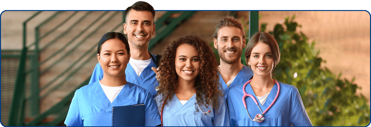 5 nurses standing together smiling