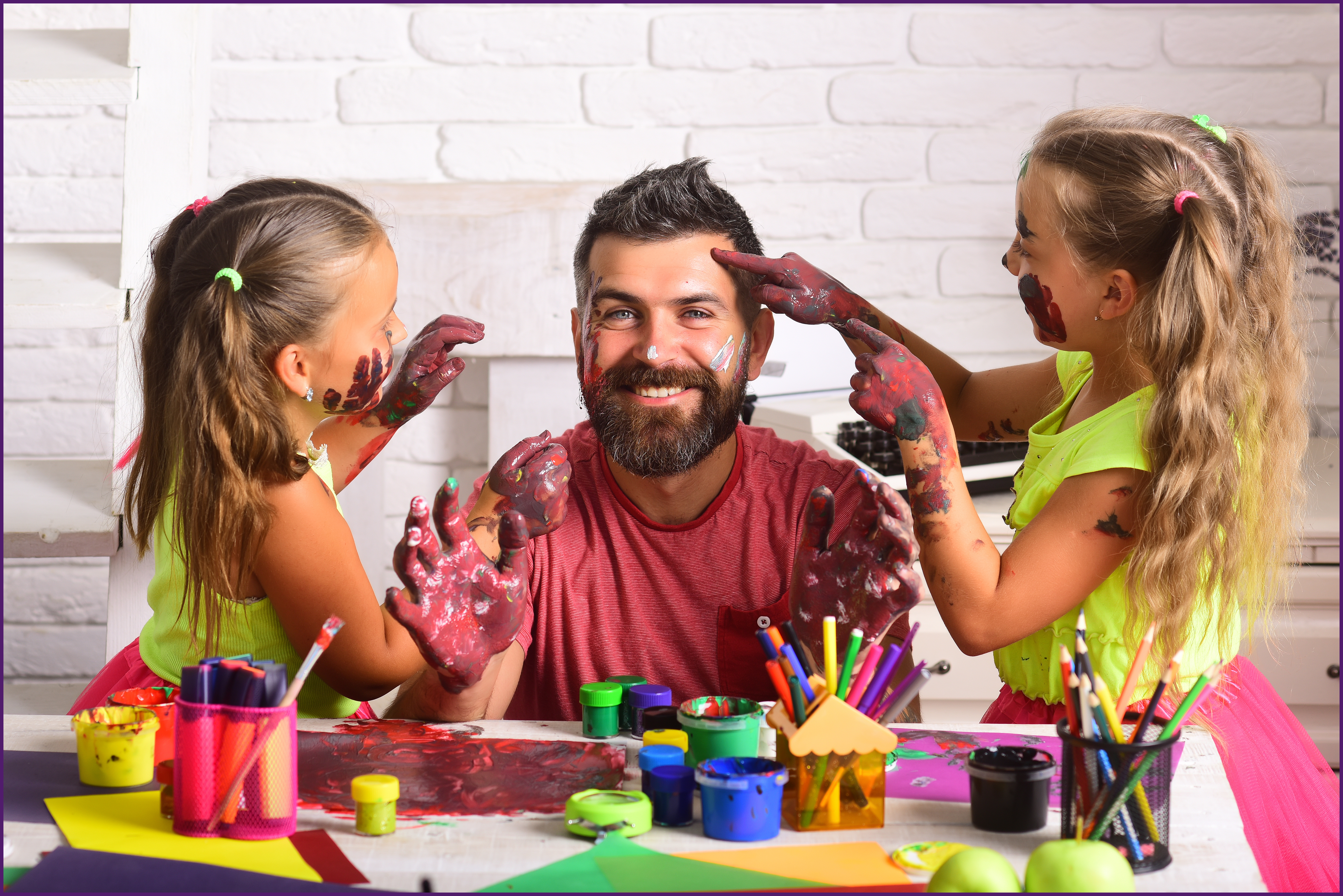 image of a father with his two daughters