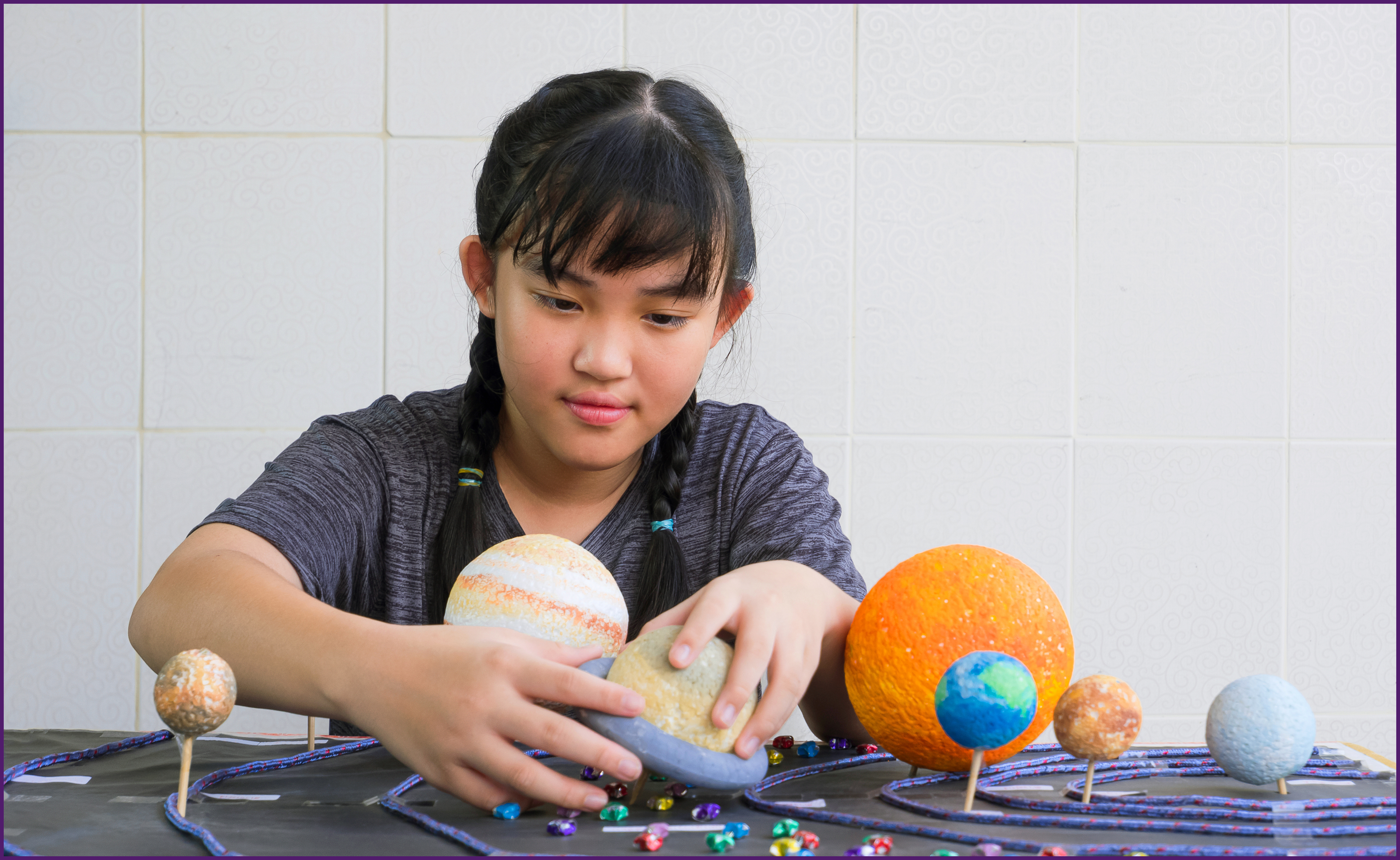 college-bound-3-ol image of a child working on a solar system project