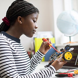 teenage girl working on robotic car