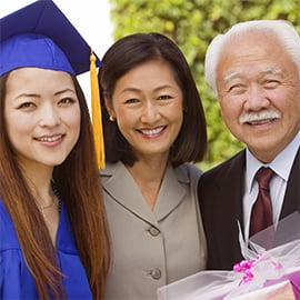 parents with daughter at her graduation