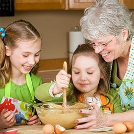 grandmother baking with her two granddaughters