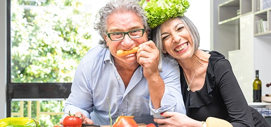 mature couple having fun while cooking