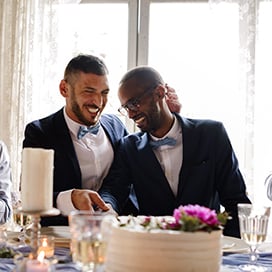 husbands celebrating at head table of wedding reception