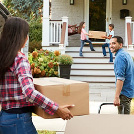 family moving boxes into new home