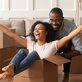 couple having fun with moving boxes