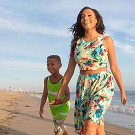 mother and son walking on the beach