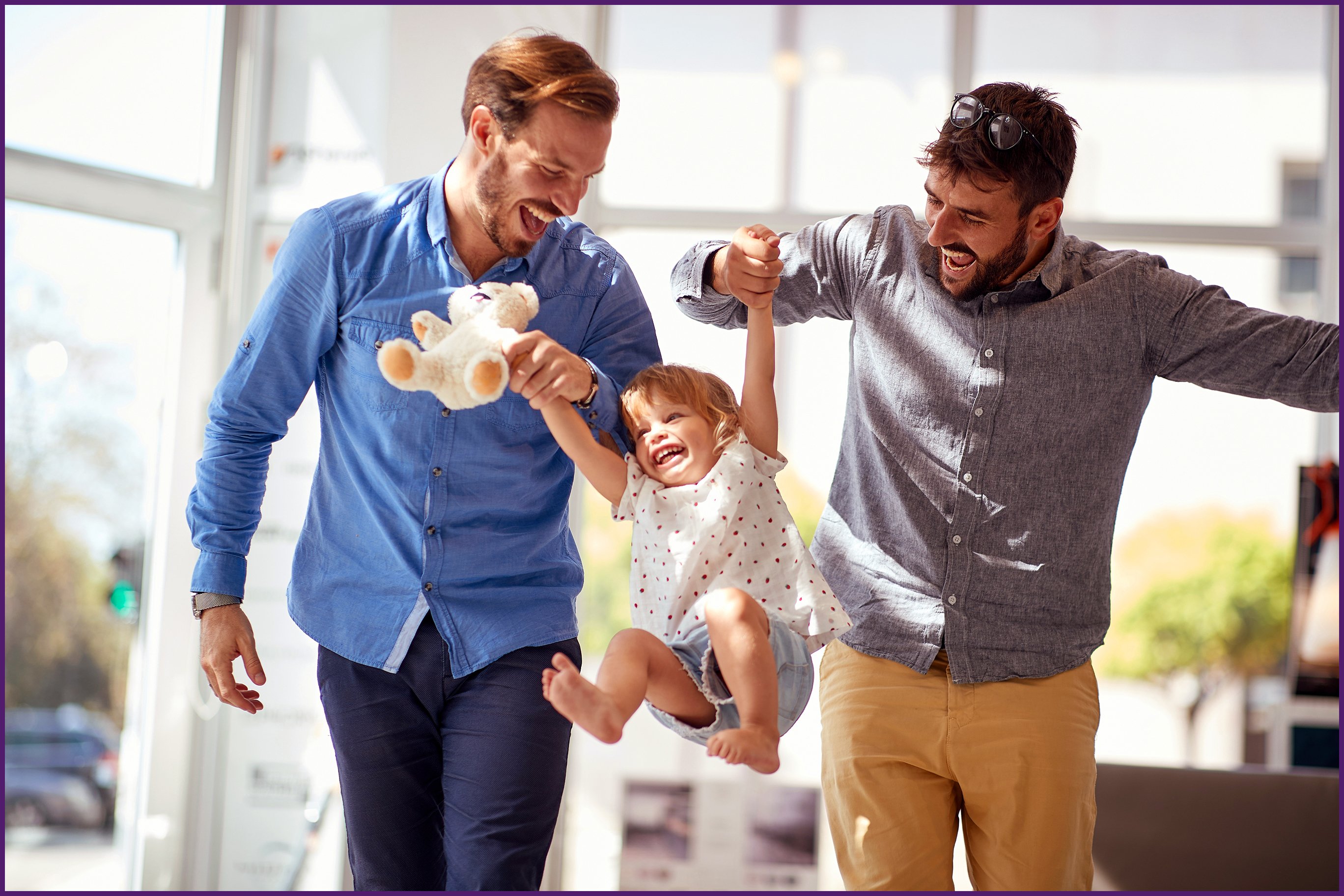 starting-a-family-2 two fathers holding up their young child