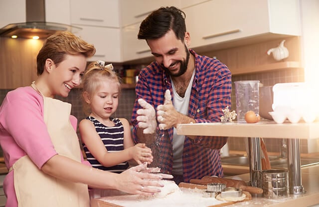 parents baking with their daughter