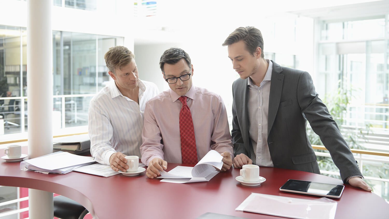 three coworkers looking over documents together