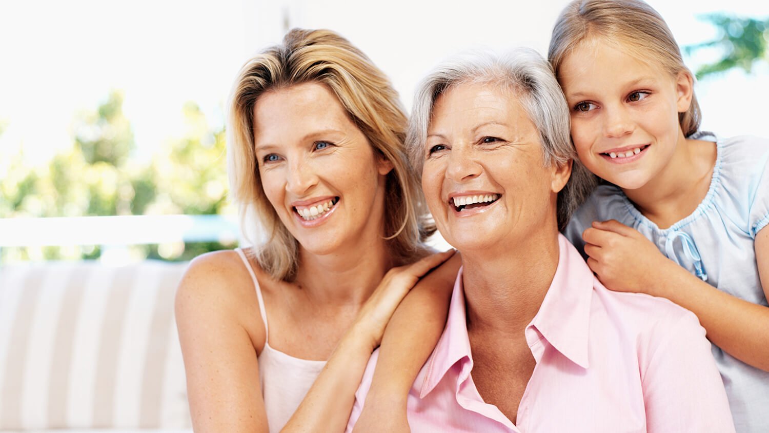 grandmother with daughter and granddaughter smiling