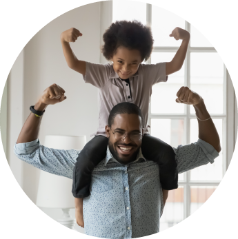 circular framed photo of a dad with his child on his shoulders and both of them flexing their arms