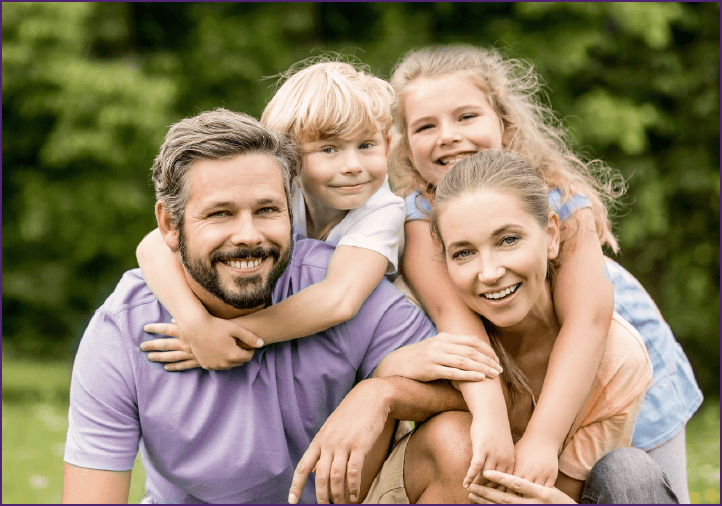 happy family of four outside