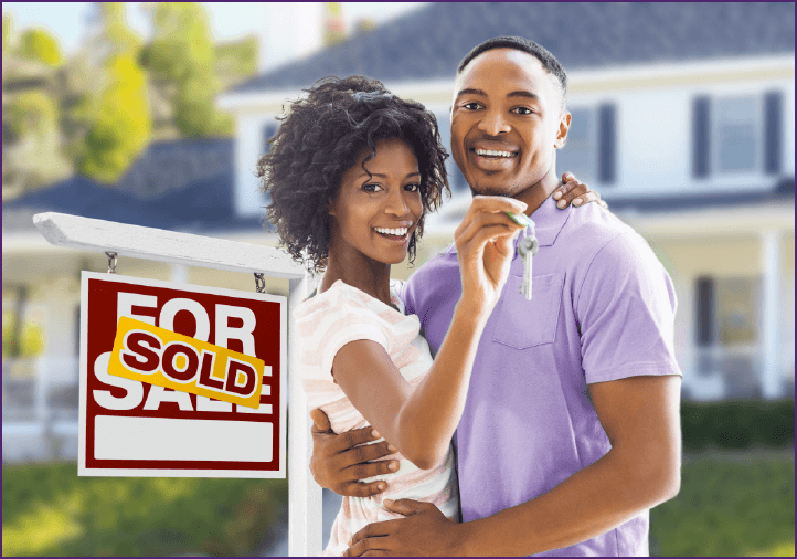 young couple in front of their new home