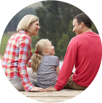 Image of a mother and father sitting with their daughter