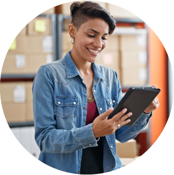 image of a female standing in a warehouse looking at a tablet