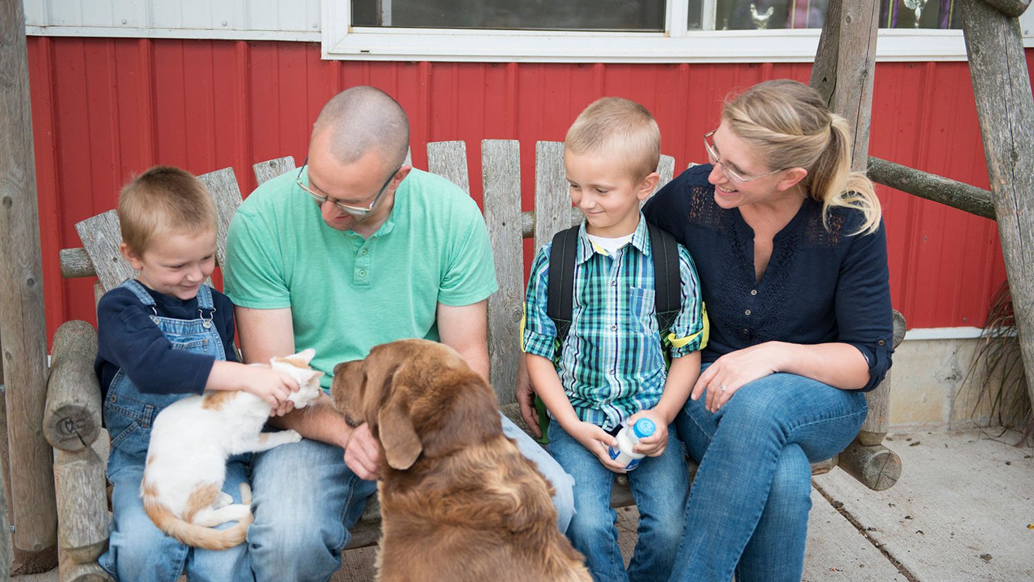 video thumbnail of young family with their dog and cat