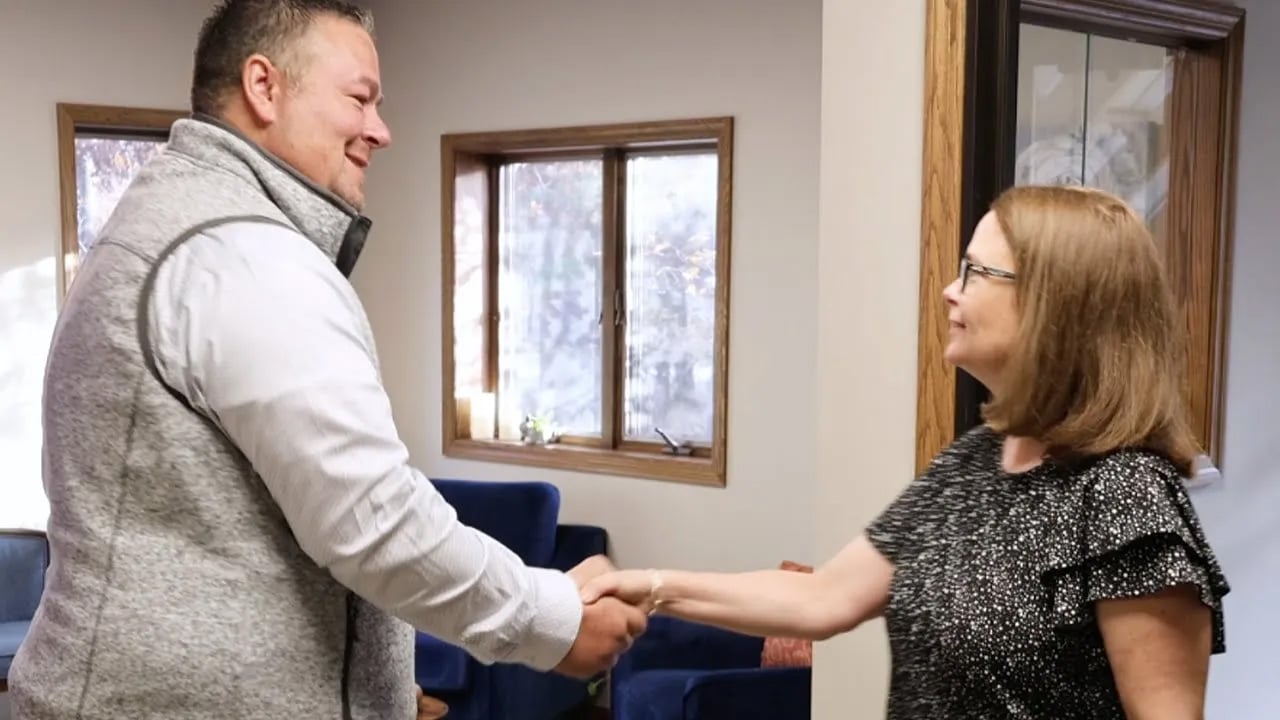 Agent Ryan Krieger shaking hands with his client